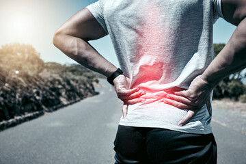 Fitness, back pain and injury with a sports man holding his sore body while outdoor for a workout....