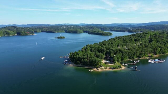 Floating sailboats and passenger ship carrying people on Solina lake in Polish Bieszczady Mountains, Poland. Subcarpathian mountains.