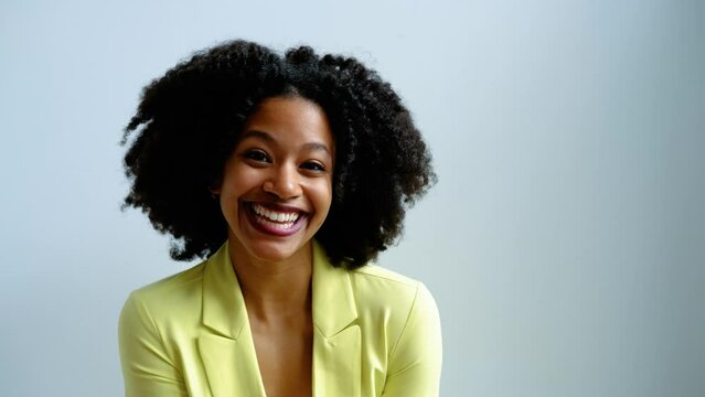 Happy positive young african american woman smiling confident, with afro hairstyle.