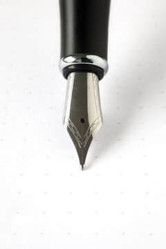 vertical close up of a silver fountain pen nib