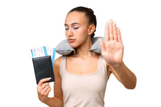 Young Arab woman with Inflatable Travel Pillow over isolated background making stop gesture and disappointed