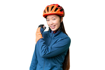 Young cyclist woman over isolated chroma key background celebrating a victory