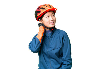 Young cyclist woman over isolated chroma key background thinking an idea