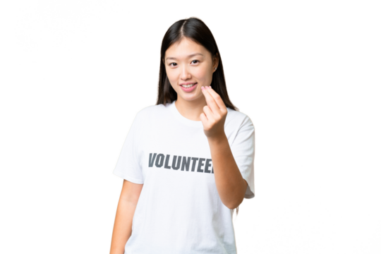 Young volunteer woman over isolated chroma key background making money gesture