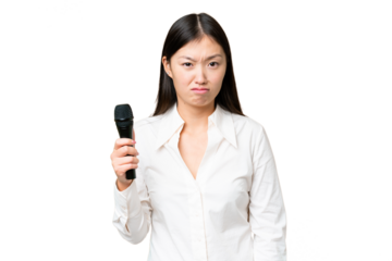 Singer picking up a microphone over isolated chroma key background with sad expression