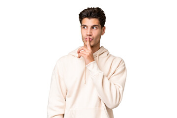 Young caucasian handsome man over isolated background showing a sign of silence gesture putting finger in mouth - obrazy, fototapety, plakaty
