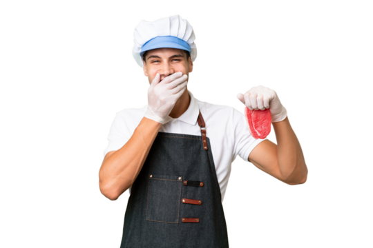 Butcher caucasian man wearing an apron and serving fresh cut meat over isolated background happy and smiling covering mouth with hand