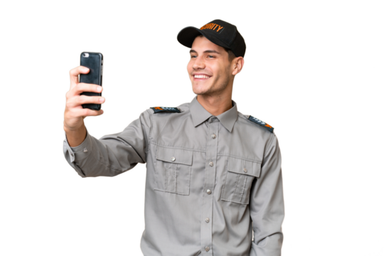 Young security man over isolated background making a selfie