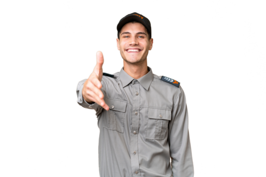 Young security man over isolated background shaking hands for closing a good deal
