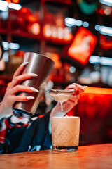 woman hand bartender making cocktail on the bar counter