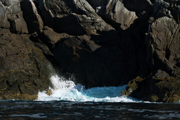 norway on the fjord, spray on rocks. Water splashes on the stones. Coastal landscape