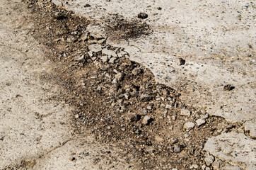 damaged road, crack in pavement. broken asphalt.