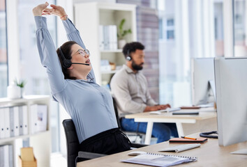 Customer service, woman with headset and stretching her arms at her desk with a computer of modern...