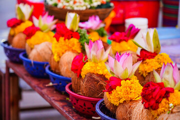 Pealed coconuts, lotus , rose and other flowers prepared for pooja, ritual worship in a temple