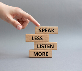 Speak less Listen more symbol. Wooden blocks with words Speak less Listen more. Beautiful grey...