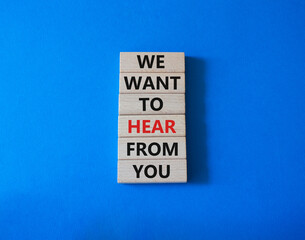 We want to hear from you symbol. Wooden blocks with words We want to hear from you. Beautiful blue background. Business and We want to hear from you. Copy space.