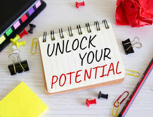 Unlock your Potential symbol. Concept words Unlock your Potential on white notebook. Beautiful wooden background. Business and Unlock your Potential concept. Copy space.