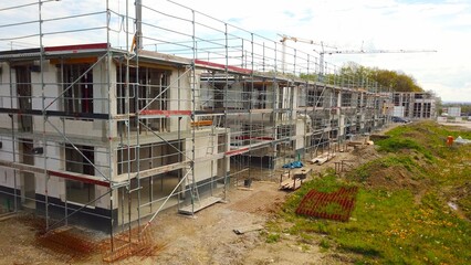 Scaffolded residential houses after completed shell construction, terraced house, building area,...