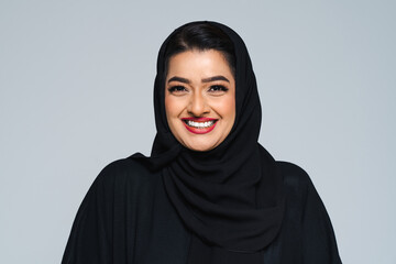 Beautiful arab middle-eastern woman with traditional abaya in studio