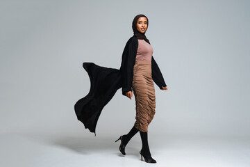 Beautiful arab middle-eastern woman with traditional abaya in studio - obrazy, fototapety, plakaty