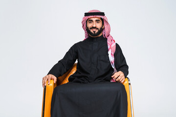 Handsome saudi arabian middle-eastern man with traditional thwab portrait in studio