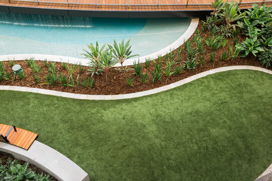 Beautiful landscaped poolside lawn area