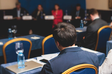 Audience at the modern conference hall listens to lecturer, people on a congress together listen to speaker on stage at master-class, corporate business seminar, venue for congress event