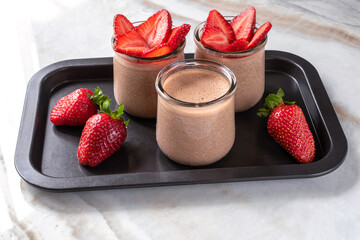 Chocolate mousse dessert with cottage cheese and strawberries for breakfast.