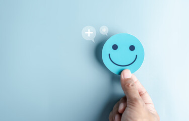 Hands holding blue happy smile face. mental health positive thinking and growth mindset concept.