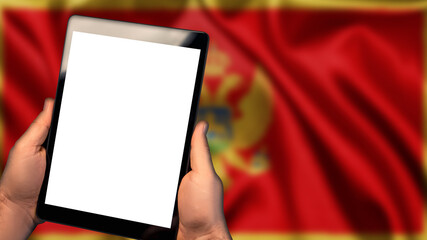 Man hold tablet phone pc gadget with white blank screen, copy space for text, image or message. Flag of Montenegro country on background. Technology, information, business

