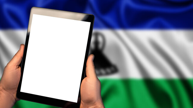 Man hold tablet phone pc gadget with white blank screen, copy space for text, image or message. Flag of Lesotho country on background. Technology, information, business
