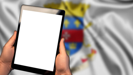 Man hold tablet phone pc gadget with white blank screen, copy space for text, image or message. Flag of Saint Barthelemy country on background. Technology, information, business
