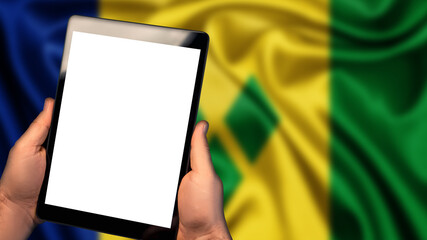 Man hold tablet phone pc gadget with white blank screen, copy space for text, image or message. Flag of Saint Vincent and the Grenadines country on background. Technology, information, business
