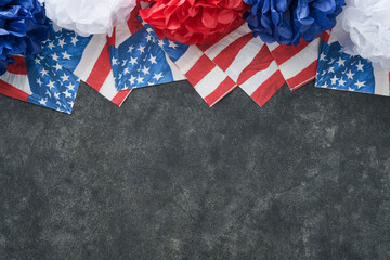 Obraz premium 4th of July background. USA paper fans, Red, blue, white stars, balloons, gold confetti on gray dark concrete background. Happy Labor, Independence or Presidents Day. American flag colors. Top view.