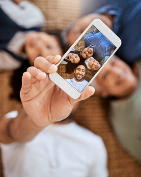 Happy family, phone screen and selfie for social media, online post or vlog on floor together at home. Top view of Grandparents, father and child smile for photo, memory or profile picture in house