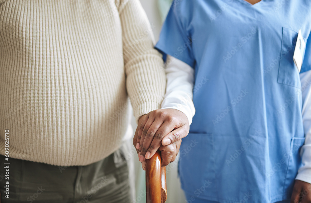 Wall mural Nurse, holding hands and senior patient with a cane for support, healthcare and kindness at nursing home. Person, caregiver and woman together for trust, elderly care and help in retirement