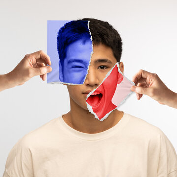 Young asian man and different emotions. Human hands holding piece of photos near face with various facial expressions. Conceptual art collage.