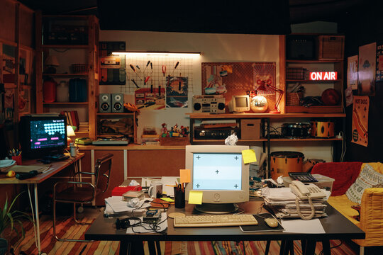 Horizontal image of furnished garage with computers and other retro objects
