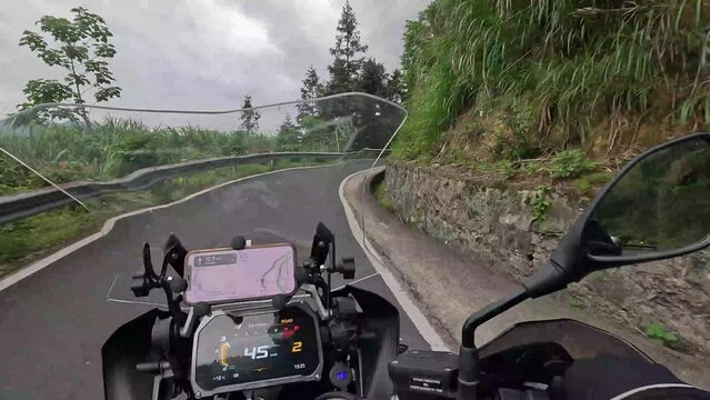 Motorcycle rider driving a motorcycle through the mountains and forests