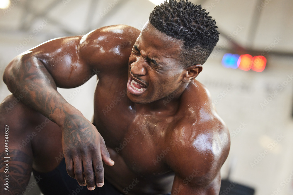 Poster Exercise, muscle and pain with a black man bodybuilder breathing in the gym, exhausted after a workout. Fitness, injury and sweat with a intense, shirtless male athlete taking a break from training