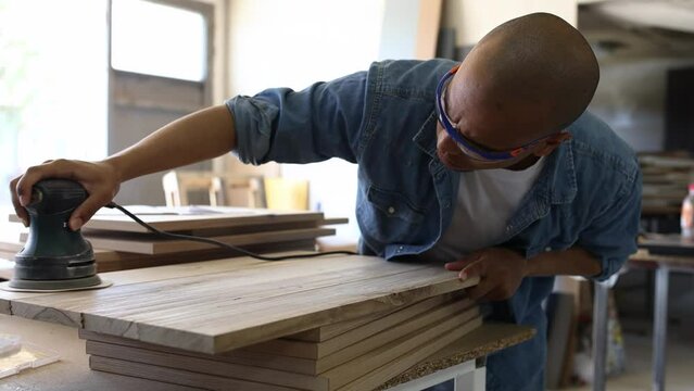 Young black man carpenter working in his workshop.	
