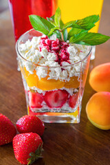Cottage cheese with peach and strawberries and some juice. Diet breakfast
