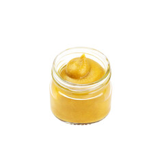 A glass jar of mustard on a white background