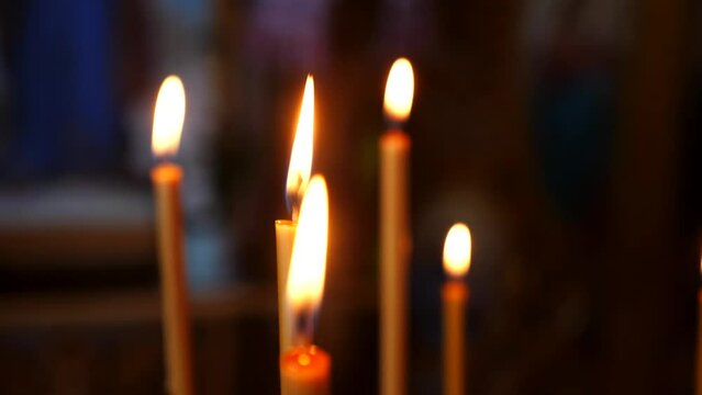 Candles are burning in the cathedral, the church. Slow motion shooting