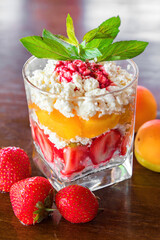 Cottage cheese with peach and strawberries and some juice. Diet breakfast