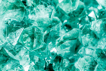 Green crystal mineral stone. Gems. Mineral crystals in the natural environment. Texture of precious and semiprecious stones. Seamless background with copy space colored shiny surface of precious stone