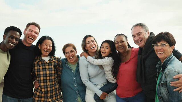 Happy multigenerational friends with different ethnicity having fun smiling on camera at house rooftop - Diversity people lifestyle