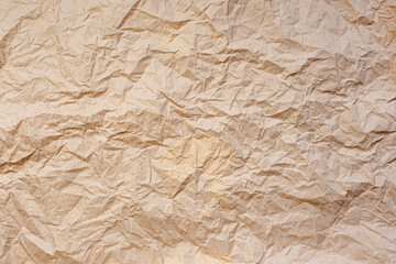 Natural abstract textured background of wrinkled beige paper.