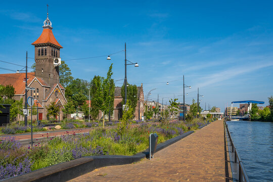 Townscape of Diemen, southeast of Amsterdam, view of Weespertrekvaart canal and Sint Petrus Banden church