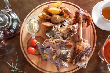 Grilled lumb with potato on wooden background